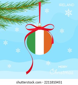 Christmas ball with the Ireland flag, decorates the Christmas tree branch. Illustration of a Christmas ball with the flag of Ireland in a Christmas tree branch on a beautiful winter background. Vector