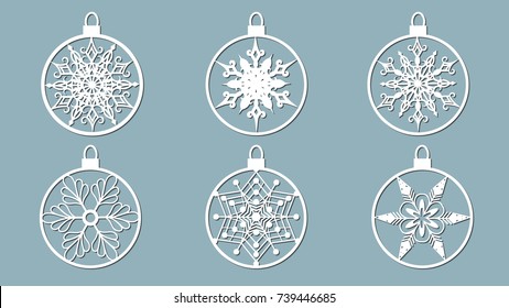 Christmas balls set with a snowflake cut out of paper. Templates for laser cutting, plotter cutting or printing. Festive background.