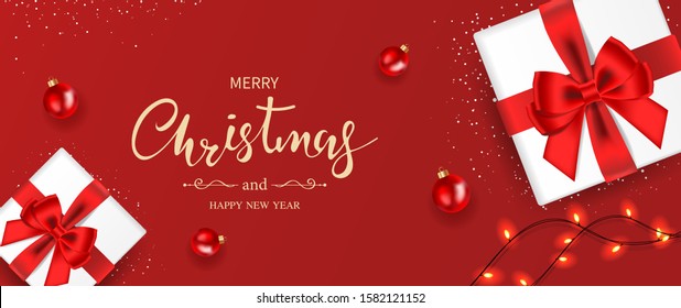 Christmas banner. Background Xmas decorated with gifts box, sparkling lights, red balls, and snowflakes. Top view. Vector illustration.