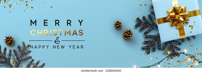 Christmas banner. Background Xmas design of sparkling lights garland, with realistic gifts box, black snowflake and glitter gold confetti. Horizontal christmas poster, greeting cards, headers, website