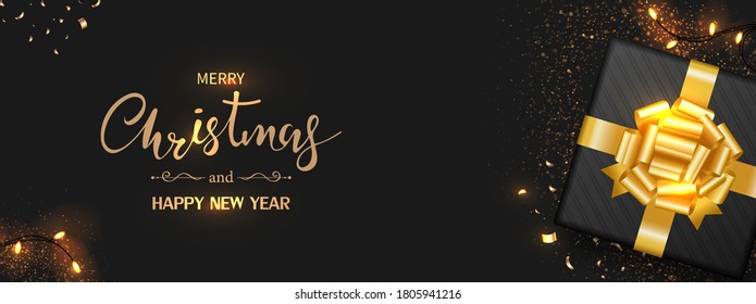 Christmas banner. Black gift box decorated with gold bow- ribbon, light , confetti isolated on black background. Top view. Xmas holiday present. Vector illustration.