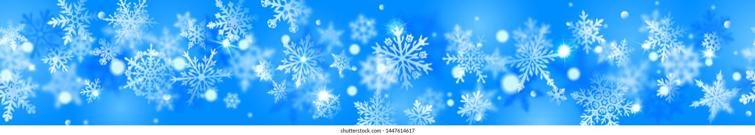 Christmas banner of complex blurred and clear snowflakes in white colors on light blue background. With horizontal repetition