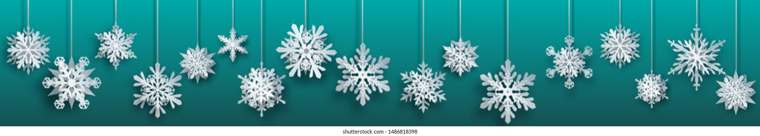 Christmas banner of large white complex paper hanging snowflakes on turquoise background