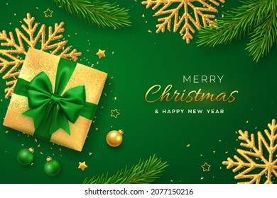 Christmas banner. Realistic gold gift box with green bow, shining snowflake, gold stars, pine branches, confetti, balls. Xmas background, horizontal poster, greeting cards, headers website. Vector.