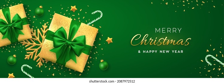 Christmas banner. Realistic gold gift boxes with green bow, gold stars, shiny golden snowflake, balls and candy canes. Xmas green background, horizontal poster, greeting card, header website. Vector.