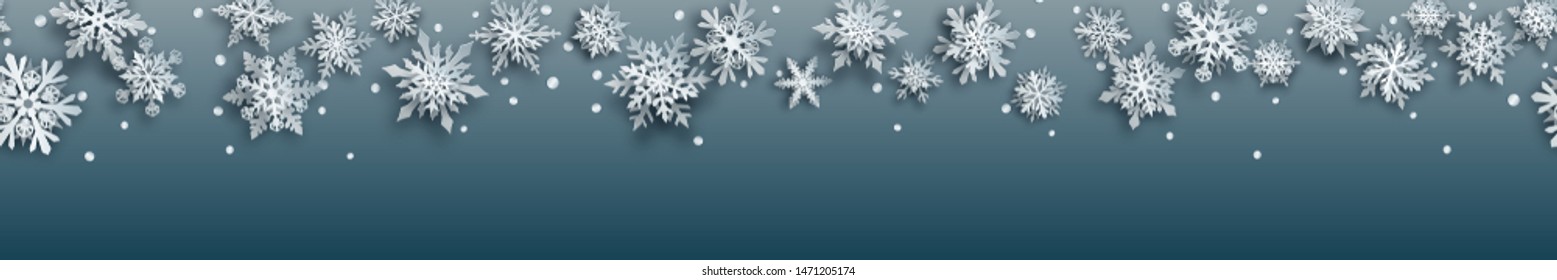 Christmas banner of white complex paper snowflakes with soft shadows on gray background. With horizontal repetition