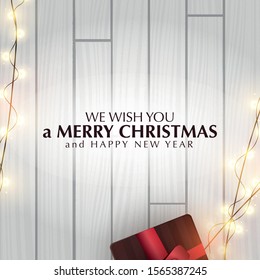 Christmas banner. Wooden Xmas Background design of sparkling lights garland, with gifts box. New Year Poster, greeting cards, headers, website