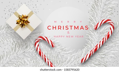 Christmas banner. Xmas background design of white pine branches, with realistic gift box, white confetti, sweets, candy canes, lollipops. Horizontal christmas poster, greeting cards, headers, website