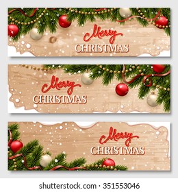 Christmas banners set with fir branches decorated with ribbons, red and gold balls and garlands. With snow frames and wood texture background. 