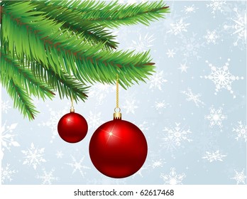Christmas baubles hanging on a fir tree branch on a snowflake background