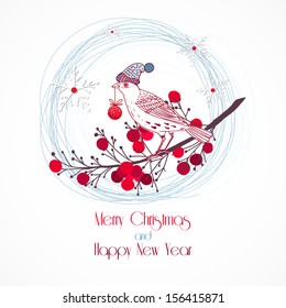 Christmas bird in knitted hat on the branch with red berries