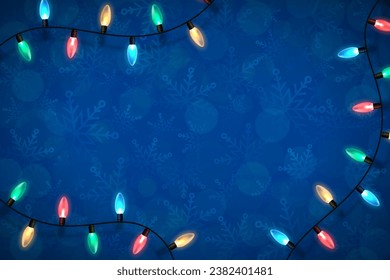 Christmas blue backdrop with lights garland over winter themed pattern with snowflakes and blurred bokeh lights. Festive design element for xmas holiday poster, banner, card or social media posting