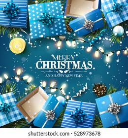 Christmas blue gift boxes,branches and baubles on blue background - Luxury Christmas greeting card