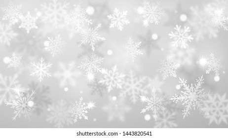 Christmas blurred background of complex defocused big and small falling snowflakes in white and gray colors with bokeh effect