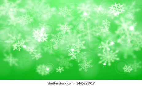 Christmas blurred background of complex defocused big and small falling snowflakes in green colors with bokeh effect