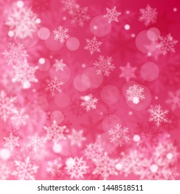 Christmas blurred background of complex defocused big and small falling snowflakes in red colors with bokeh effect