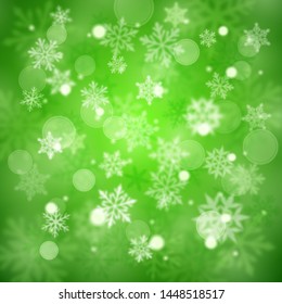 Christmas blurred background of complex defocused big and small falling snowflakes in green colors with bokeh effect