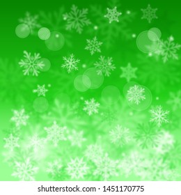 Christmas blurred background of complex defocused big and small falling snowflakes in green colors with bokeh effect