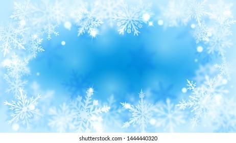 Christmas blurred background with frame of complex defocused big and small snowflakes in light blue colors with bokeh effect