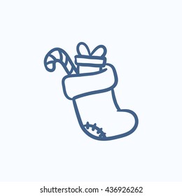 Inicio navideño con regalo y caramelo de caramelo icono de dibujo vectorial aislado en el fondo. Mano dibujó el arranque de Navidad con un ícono de regalo y un bastón de caramelo. Icono de boceto de arranque de Navidad para infografía, sitio web o aplicación.