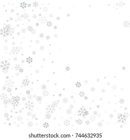 Christmas border or frame with random scatter falling silver snowflakes isolated on white.