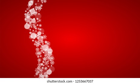 Christmas border with white snowflakes on red background. Santa Claus colors. Horizontal Merry Christmas border for season sales, banners, invitations, retail offers. Falling snow. Frosty winter back.