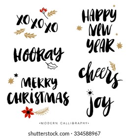 Christmas Calligraphy Phrases. XOXO. Happy New Year. Merry Christmas. Hooray. Cheers. Joy. Handwritten Modern Brush Lettering. Hand Drawn Design Elements.