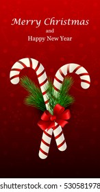 Christmas candy cane decorated with a bow and Christmas tree branches