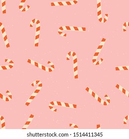 Christmas candy cane seamless pattern on pink background. Traditional christmasy food for celebration of New Year. 