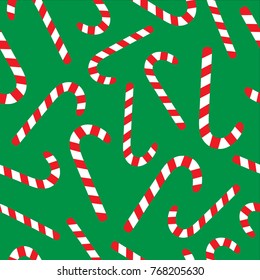 Christmas candy cane vector seamless pattern. Festive green background with sweet red and white candy canes.