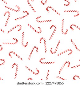 Christmas candy canes on white background. Vector seamless pattern