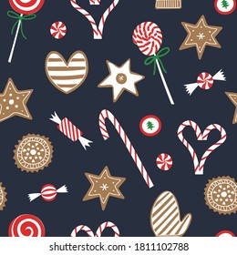 Christmas candy and cookie seamless pattern. 
Flat red and white sweet cane, lollipop, bonbons, gingerbread cookies on blue background. Festive xmas and new year print for wrapping or wallpaper.