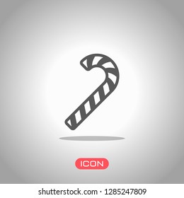 Christmas candy icon, sweet striped lollipop. Icon under spotlight. Gray background