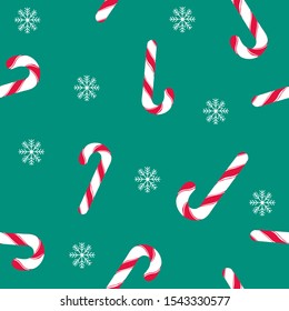 Christmas candy pattern on green background. Seamless texture with Christmas lollipop and snowflakes. Winter holidays print for textile, wallpaper, fabric. Vector illustration.