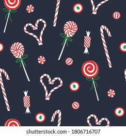 Christmas candy seamless pattern. 
Flat red and white sweet cane, lollipop, bonbons on blue background. Festive xmas and new year print for wrapping or wallpaper.