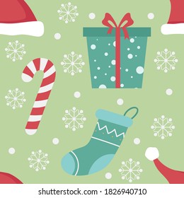 Christmas cane, gift box, a Christmas stocking and white snowflakes on light green background. Simple design for web and print