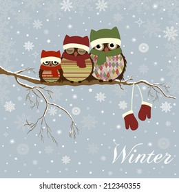 Christmas card a branch with family of owls in winter