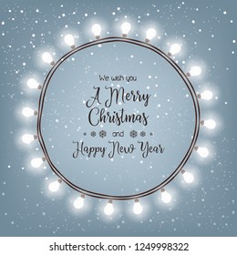 Christmas card with a bright wreath of light bulbs on a snowy background
