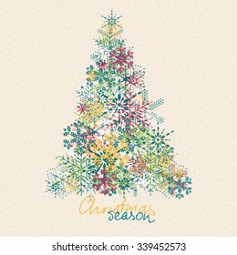 Christmas card, colorful snowflakes formed as pine tree and snowy background