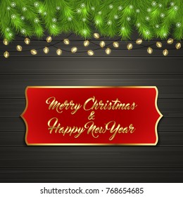 Christmas card with Cristmas fir tree branches on top, glowing garland and snow flakes on black wooden board with greeting text Merry Chrismas and Happy New Year on red label with gold frame