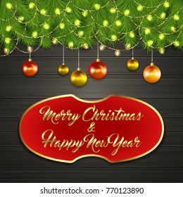 Christmas card with Cristmas fir tree branches on top, glowing garland and Christmas tree balls on black wooden board with greeting text Merry Chrismas and Happy New Year on red label with gold frame