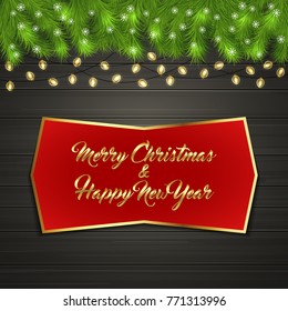 Christmas card with Cristmas fir tree branches on top, glowing garland and snow flakes on black wooden board with greeting text Merry Chrismas and Happy New Year on red label with gold frame
