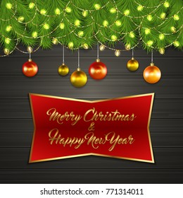 Christmas card with Cristmas fir tree branches on top, glowing garland and Christmas tree balls on black wooden board with greeting text Merry Chrismas and Happy New Year on red label with gold frame