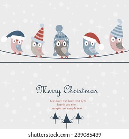 Christmas card with cute owls in winter caps sitting on wires. Merry christmas and happy new year greeting card.