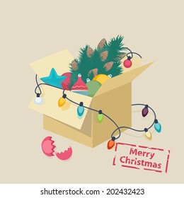 Christmas card design with a box of toys and colorful decorations, lights and a Christmas tree with a broken eggshell in front and the text - Merry Christmas