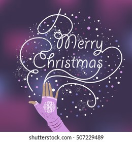 Christmas card. Female hand in a mitten writes on a frozen window.