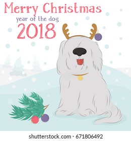 Christmas card with large, shaggy dog breed Bobtail with decorative reindeer and Christmas balls on a blue background with snow.