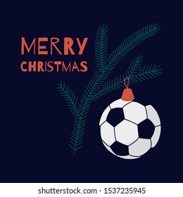 Christmas card on football theme. On a fir branch hangs a toy similar to a soccer ball, dominated by green, red, white and navy blue.