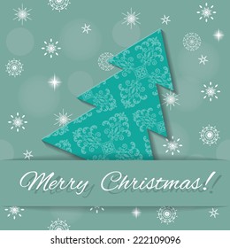 Christmas card. Paper cut out Christmas tree on blurred winter background.