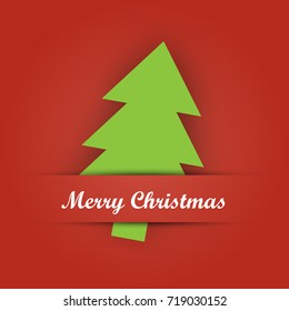 Christmas card paper pocket with green tree papercut and Merry Christmas label on red background.